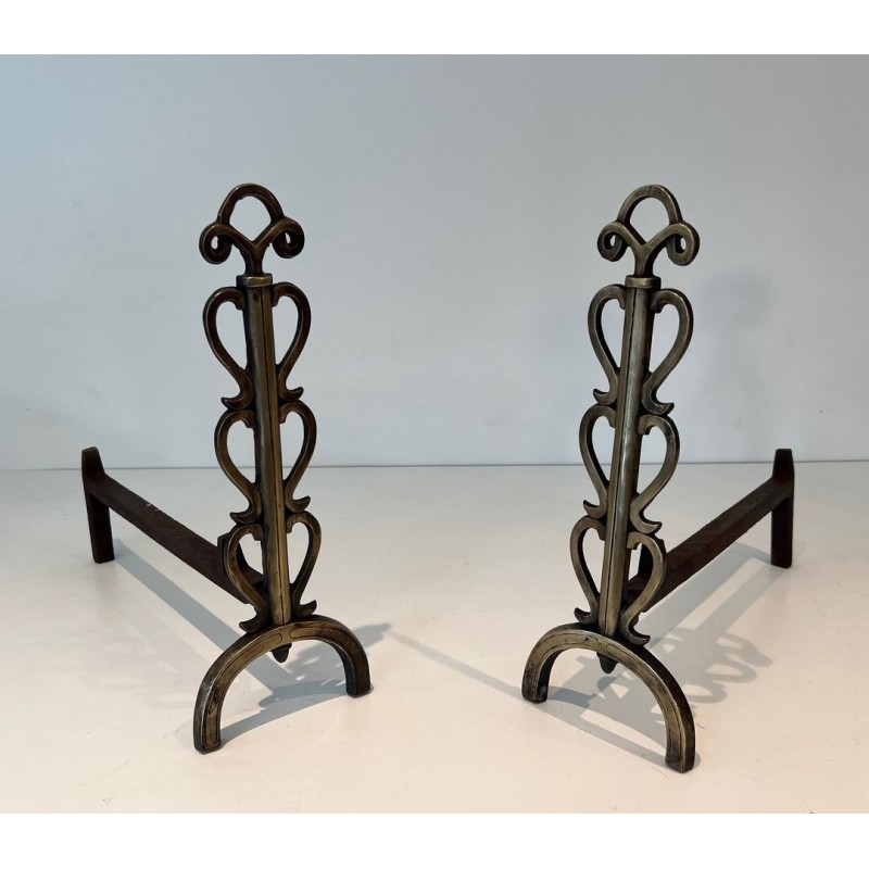Pair of Brass and Iron Andirons with Stacked Scroll-Column Uprights on Arched Bases, in the Style of Raymond Subes