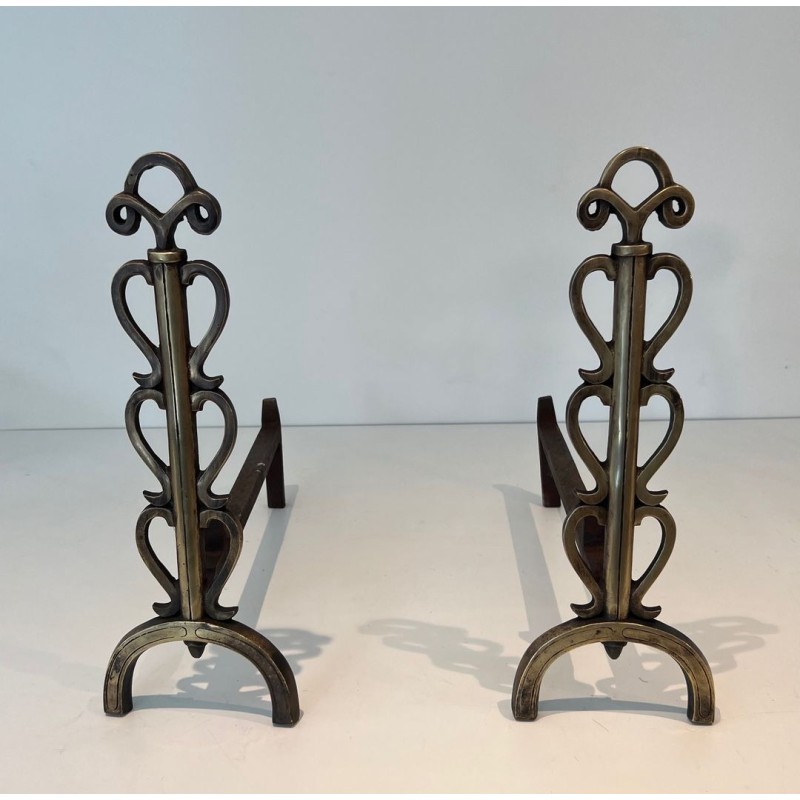 Pair of Brass and Iron Andirons with Stacked Scroll-Column Uprights on Arched Bases, in the Style of Raymond Subes
