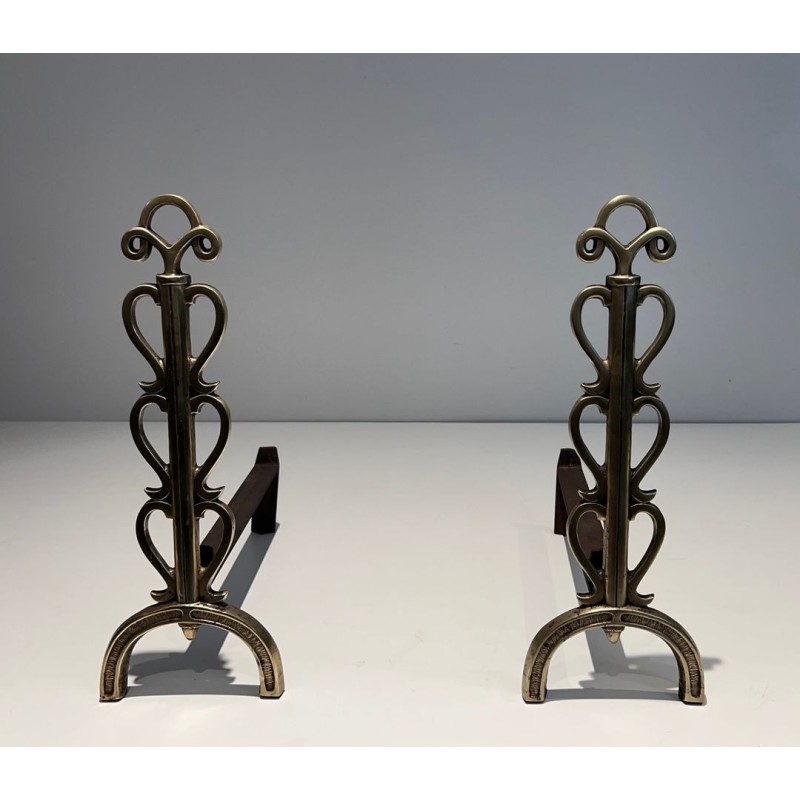 Pair of Brass and Wrought Iron Andirons with Stacked Heart-Lobe Uprights in the Manner of Raymond Subes. France. Circa 1940.