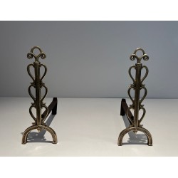 Pair of Brass and Wrought Iron Andirons with Stacked Heart-Lobe Uprights in the Manner of Raymond Subes. France. Circa 1940.