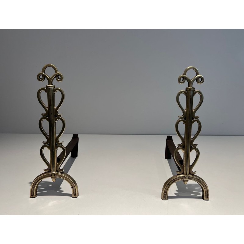 Pair of Brass and Wrought Iron Andirons with Stacked Heart-Lobe Uprights in the Manner of Raymond Subes. France. Circa 1940.