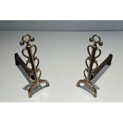 Pair of Brass and Wrought Iron Andirons with Stacked Heart-Lobe Uprights in the Manner of Raymond Subes. France. Circa 1940.