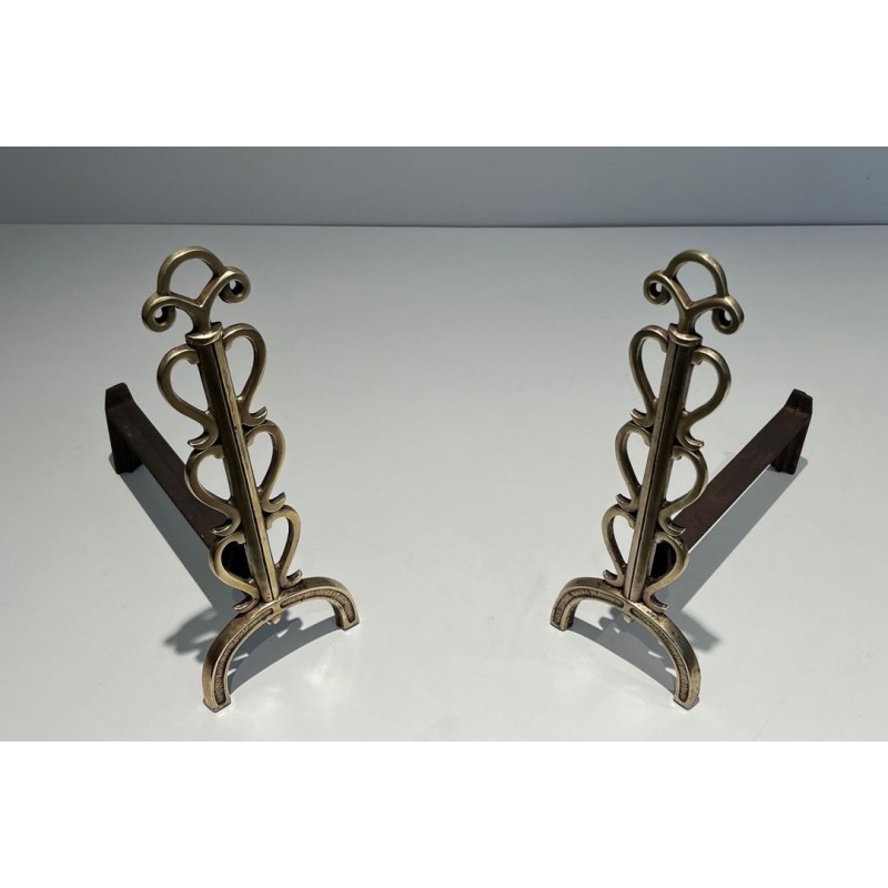 Pair of Brass and Wrought Iron Andirons with Stacked Heart-Lobe Uprights in the Manner of Raymond Subes. France. Circa 1940.