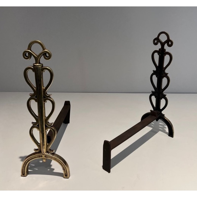 Pair of Brass and Wrought Iron Andirons with Stacked Heart-Lobe Uprights in the Manner of Raymond Subes. France. Circa 1940.
