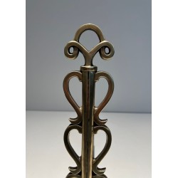 Pair of Brass and Wrought Iron Andirons with Stacked Heart-Lobe Uprights in the Manner of Raymond Subes. France. Circa 1940.