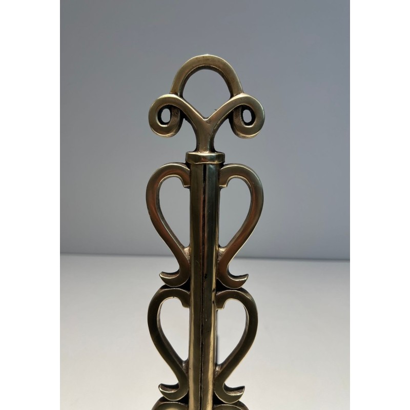 Pair of Brass and Wrought Iron Andirons with Stacked Heart-Lobe Uprights in the Manner of Raymond Subes. France. Circa 1940.