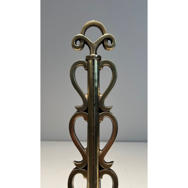 Pair of Brass and Wrought Iron Andirons with Stacked Heart-Lobe Uprights in the Manner of Raymond Subes. France. Circa 1940.