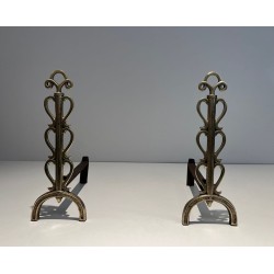 Pair of Brass and Wrought Iron Andirons with Stacked Heart-Lobe Uprights in the Manner of Raymond Subes. France. Circa 1940.
