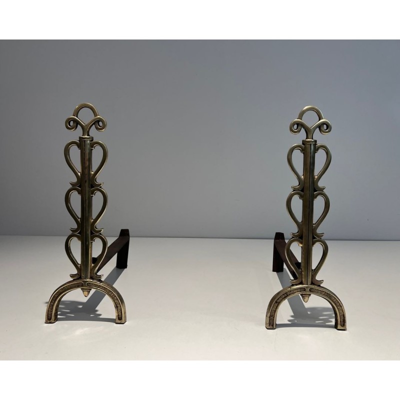 Pair of Brass and Wrought Iron Andirons with Stacked Heart-Lobe Uprights in the Manner of Raymond Subes. France. Circa 1940.