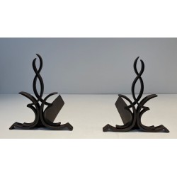 Pair of Wrought Iron Andirons with Figure-Eight Loop Uprights and Scrolled Foliate Feet by Raymond Subes. France. Circa 1940.