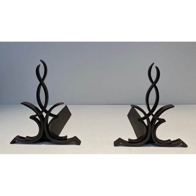 Pair of Wrought Iron Andirons with Figure-Eight Loop Uprights and Scrolled Foliate Feet by Raymond Subes. France. Circa 1940.