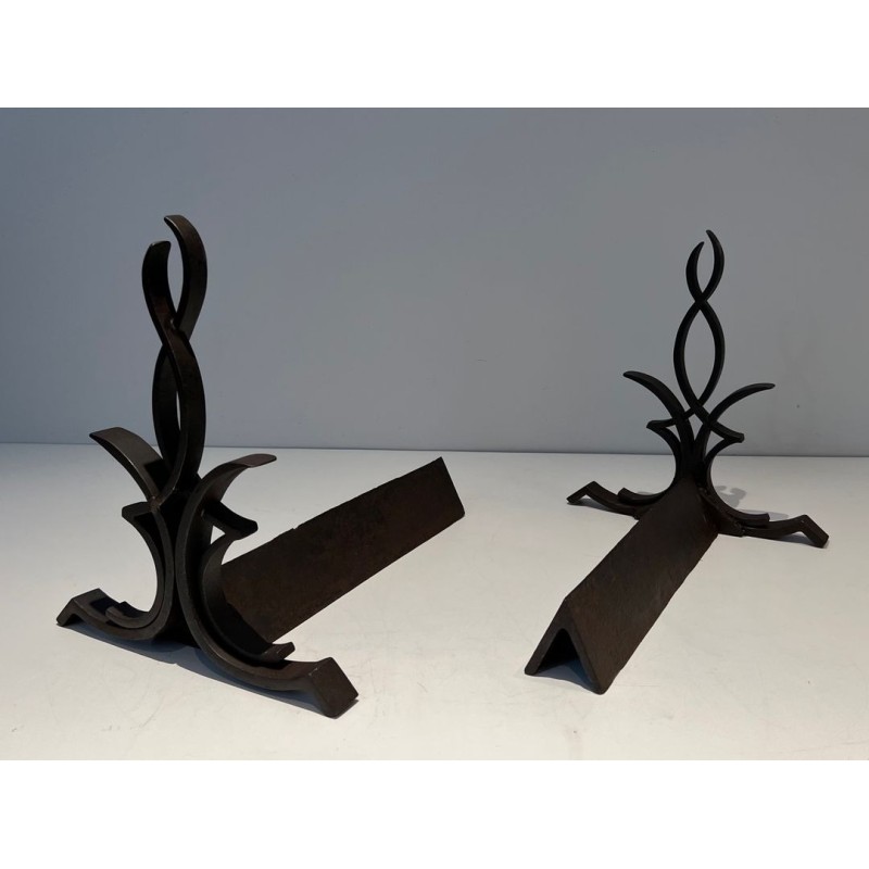 Pair of Wrought Iron Andirons with Figure-Eight Loop Uprights and Scrolled Foliate Feet by Raymond Subes. France. Circa 1940.