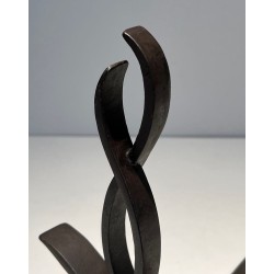 Pair of Wrought Iron Andirons with Figure-Eight Loop Uprights and Scrolled Foliate Feet by Raymond Subes. France. Circa 1940.