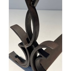 Pair of Wrought Iron Andirons with Figure-Eight Loop Uprights and Scrolled Foliate Feet by Raymond Subes. France. Circa 1940.