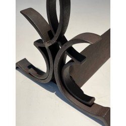 Pair of Wrought Iron Andirons with Figure-Eight Loop Uprights and Scrolled Foliate Feet by Raymond Subes. France. Circa 1940.