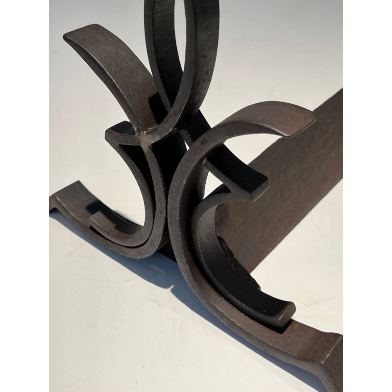 Pair of Wrought Iron Andirons with Figure-Eight Loop Uprights and Scrolled Foliate Feet by Raymond Subes. France. Circa 1940.