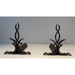 Pair of Wrought Iron Andirons with Figure-Eight Loop Uprights and Scrolled Foliate Feet by Raymond Subes. France. Circa 1940.