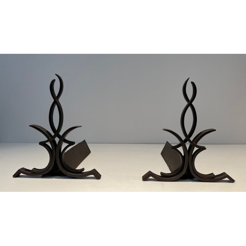 Pair of Wrought Iron Andirons with Figure-Eight Loop Uprights and Scrolled Foliate Feet by Raymond Subes. France. Circa 1940.