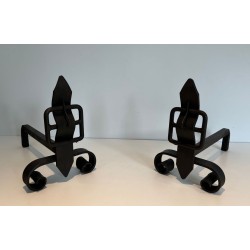 Pair of Wrought Iron Andirons with Flame Finials and Strap-Buckle Midsection. France. Circa 1950.