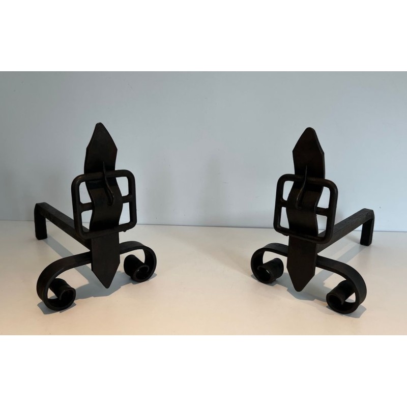 Pair of Wrought Iron Andirons with Flame Finials and Strap-Buckle Midsection. France. Circa 1950.