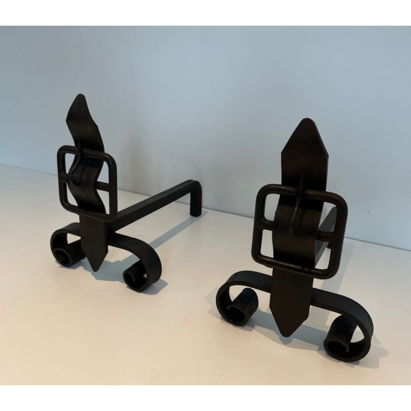 Pair of Wrought Iron Andirons with Flame Finials and Strap-Buckle Midsection. France. Circa 1950.