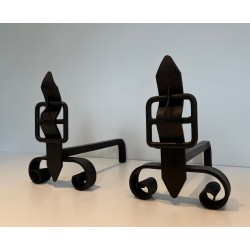 Pair of Wrought Iron Andirons with Flame Finials and Strap-Buckle Midsection. France. Circa 1950.
