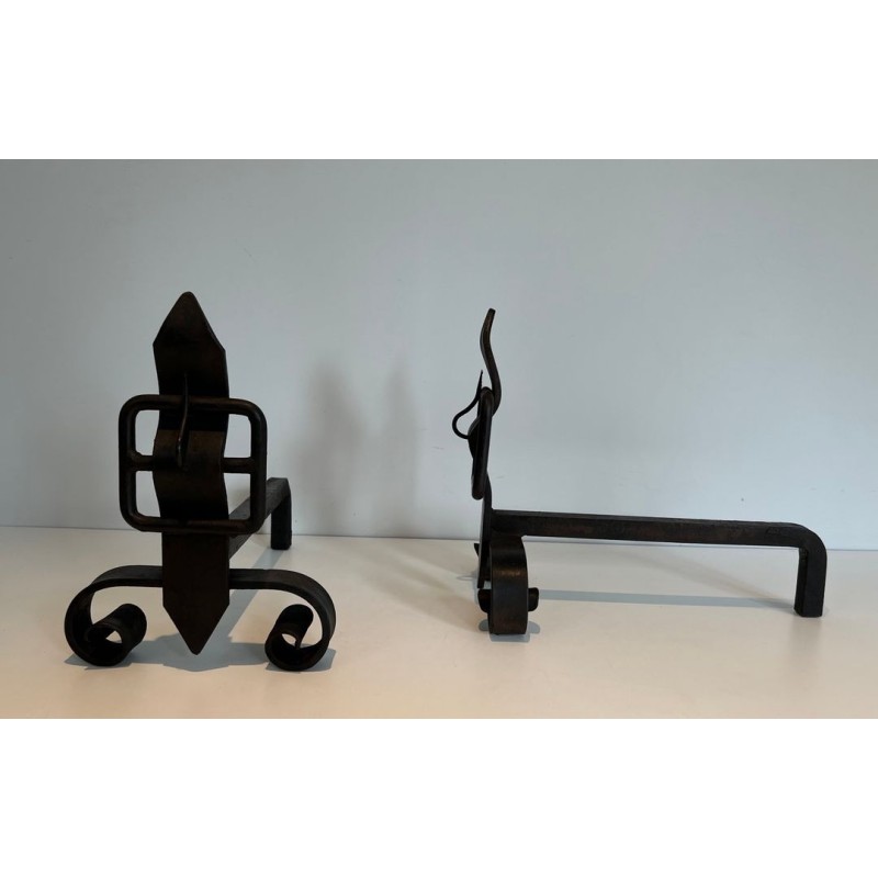 Pair of Wrought Iron Andirons with Flame Finials and Strap-Buckle Midsection. France. Circa 1950.