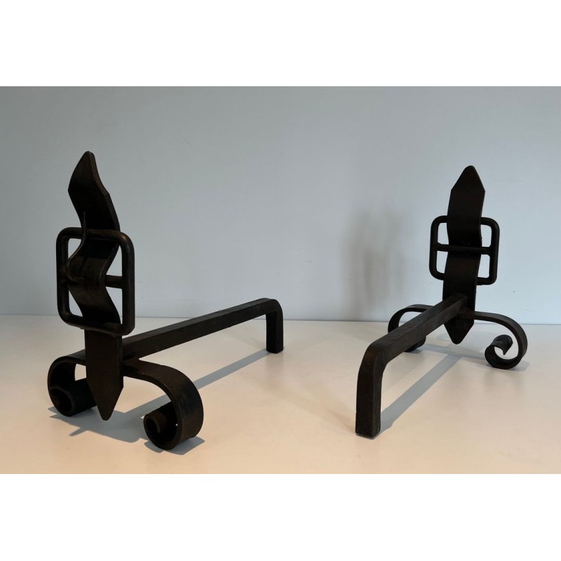 Pair of Wrought Iron Andirons with Flame Finials and Strap-Buckle Midsection. France. Circa 1950.