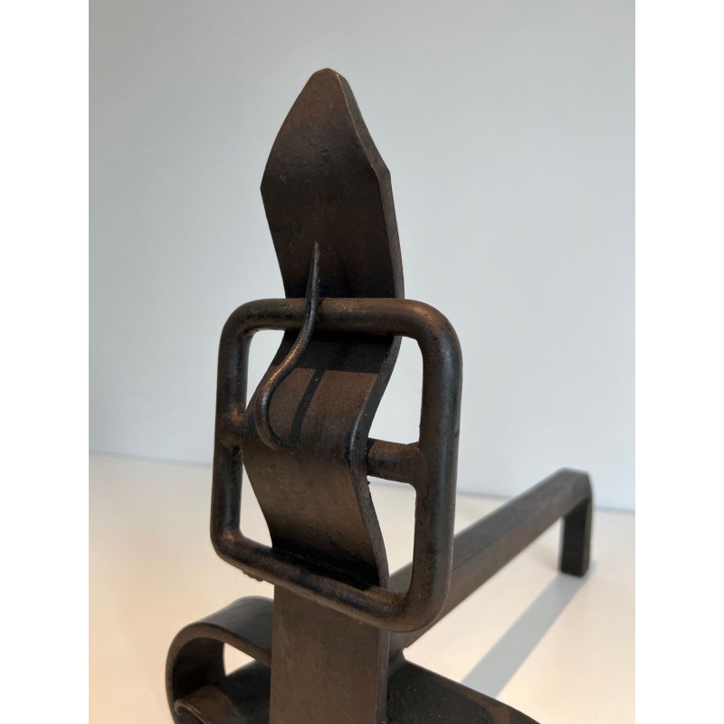 Pair of Wrought Iron Andirons with Flame Finials and Strap-Buckle Midsection. France. Circa 1950.