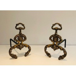 Pair of Neoclassical Bronze and Wrought Iron Andirons with Lion Mascarons. France. Circa 1940.