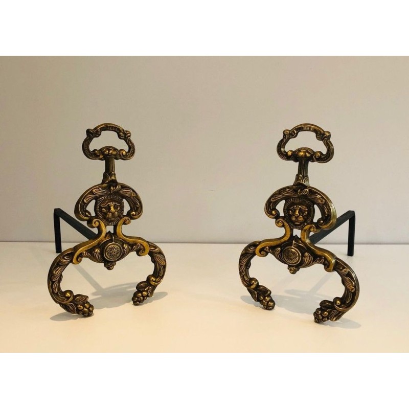 Pair of Neoclassical Bronze and Wrought Iron Andirons with Lion Mascarons. France. Circa 1940.