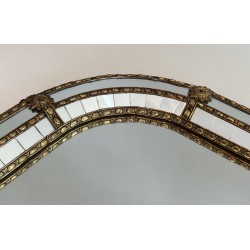 Multi-facets mirror rounded on the corners with brass garlands