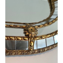 Multi-facets mirror rounded on the corners with brass garlands
