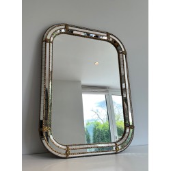 Multi-facets mirror rounded on the corners with brass garlands
