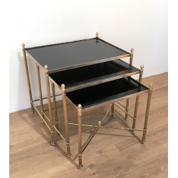 Set of Three Neoclassical Brass Nesting Tables with Black Lacquered Glass Tops by Maison Jansen, Circa 1940