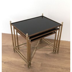 Set of Three Neoclassical Brass Nesting Tables with Black Lacquered Glass Tops by Maison Jansen, Circa 1940