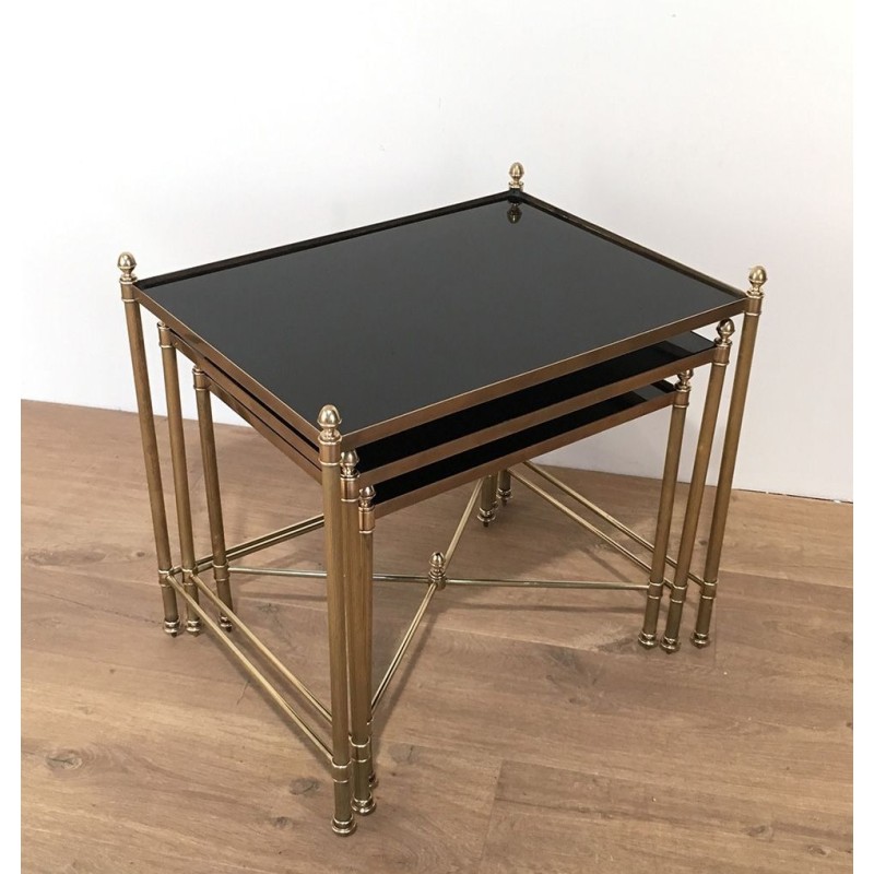 Set of Three Neoclassical Brass Nesting Tables with Black Lacquered Glass Tops by Maison Jansen, Circa 1940
