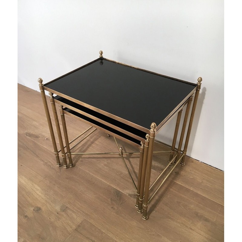 Set of Three Neoclassical Brass Nesting Tables with Black Lacquered Glass Tops by Maison Jansen, Circa 1940