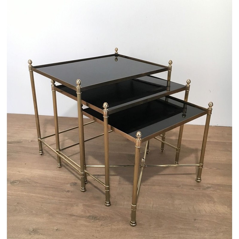 Set of Three Neoclassical Brass Nesting Tables with Black Lacquered Glass Tops by Maison Jansen, Circa 1940