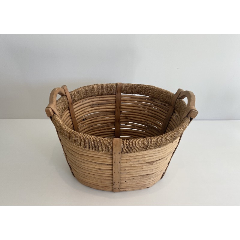 Rattan, rope and wood log basket, a testament to French artisanal craft.