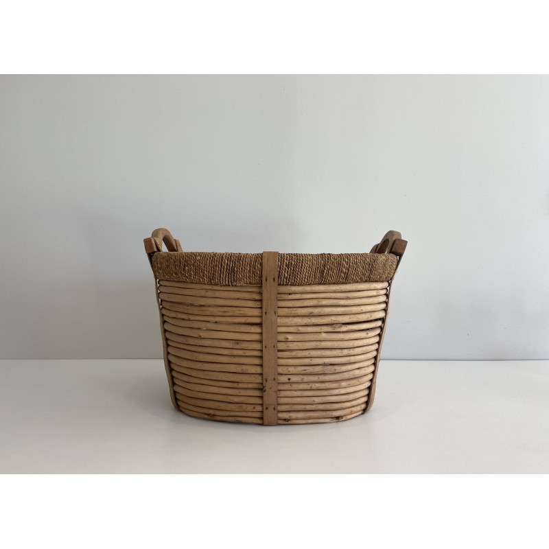Rattan, rope and wood log basket, a testament to French artisanal craft.