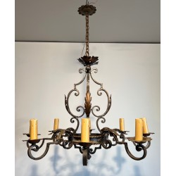 Important lustre en fer forgé à huit bras de lumières, au dessin sculptural et à la présence décorative affirmée.
