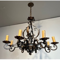 Important lustre en fer forgé à huit bras de lumières, au dessin sculptural et à la présence décorative affirmée.